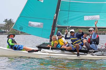 Kids on Hobie waving 