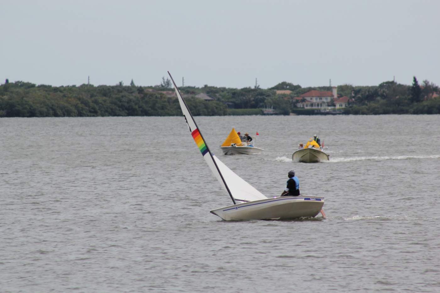 Boat with rainbow sail on the water
