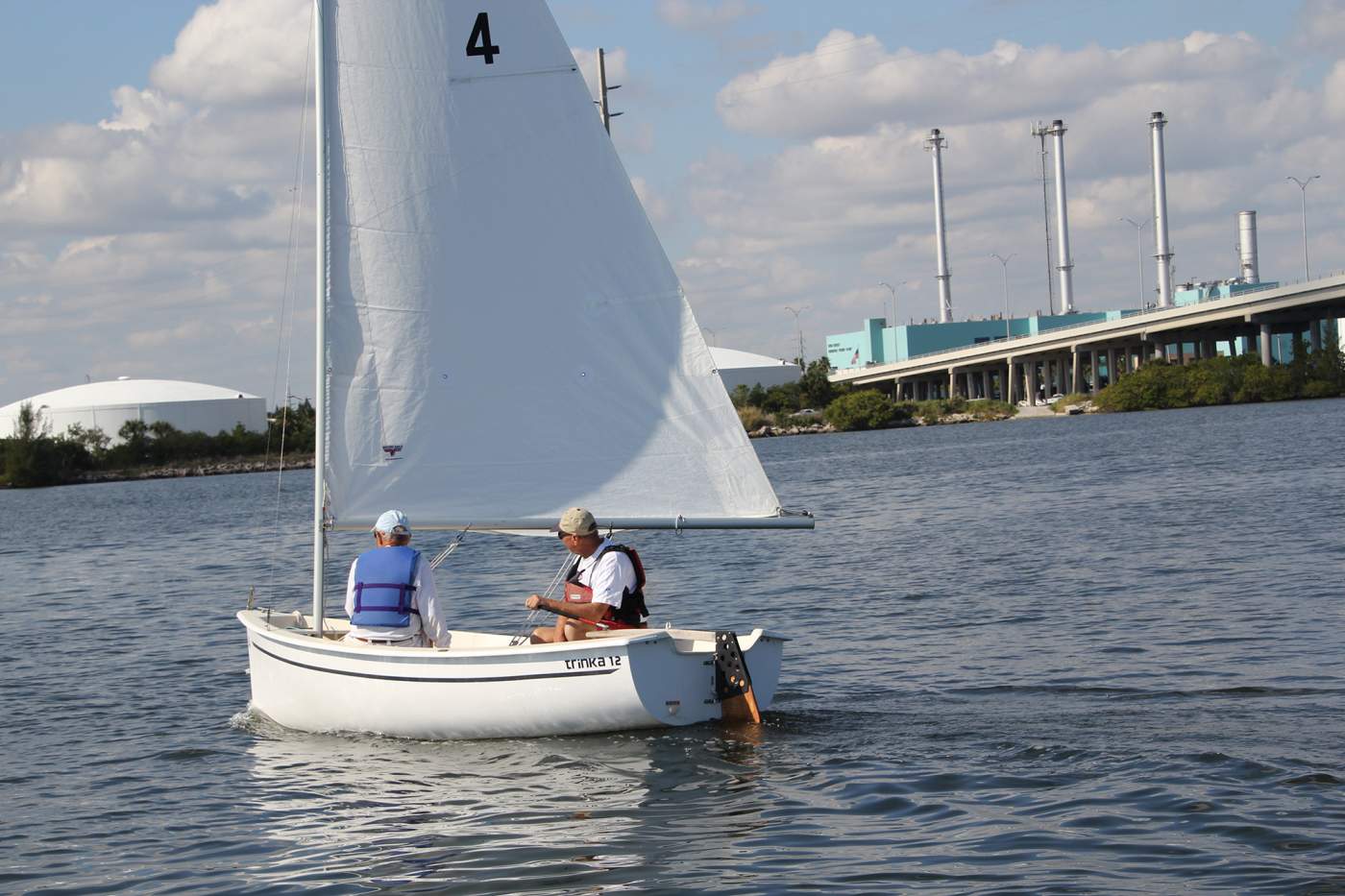 two Sailors in boat facing forward sitting