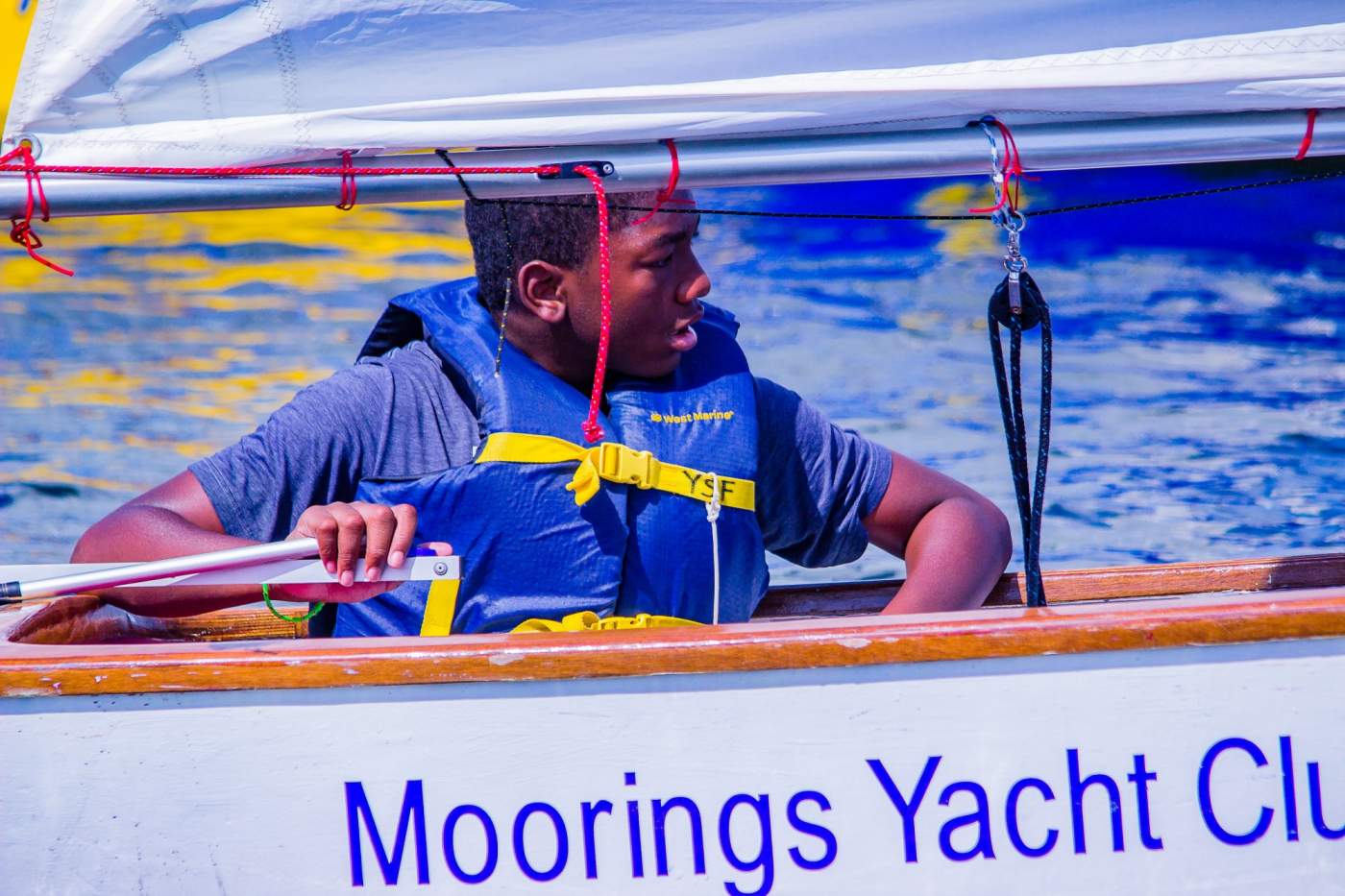Young sailor in Moorings boat