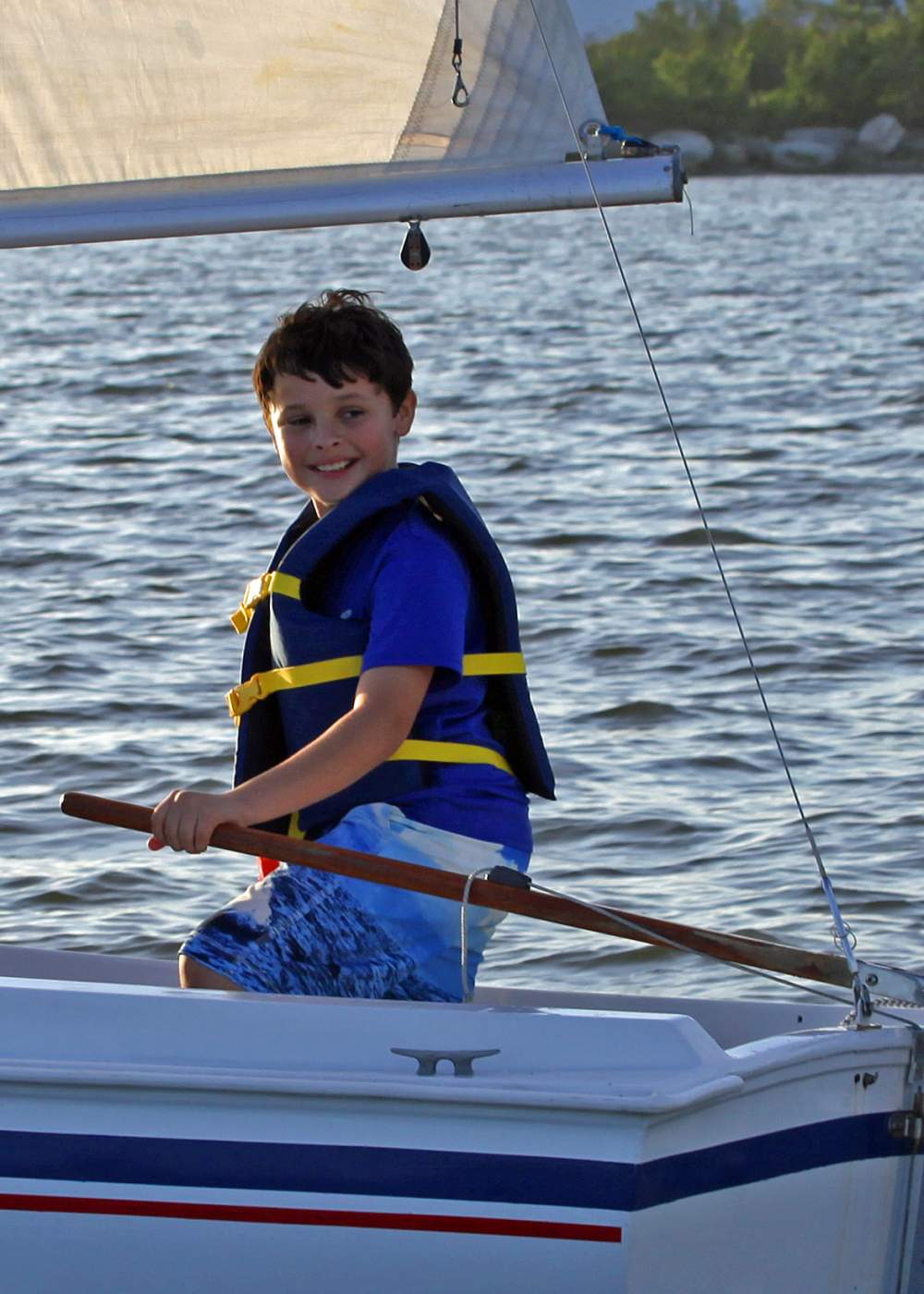 Young boy smiling while sailing