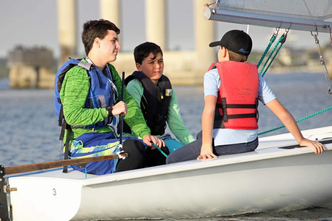 Three youth sailing